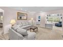 Bright living room featuring neutral colors, carpet floors, recessed lighting, and a separate office nook at 2450 Shelby Ln, Clermont, FL 34711