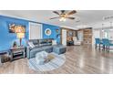 Living room with blue walls, wood flooring, and stylish leather furniture at 506 Parrott Rd, Auburndale, FL 33823