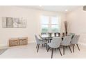 Bright dining area featuring a glass-top table and gray chairs at 7705 Fairfax Dr, Kissimmee, FL 34747