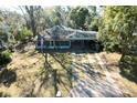 An aerial view of a single-story home with a long driveway and mature trees around the property at 922 Se 13Th St, Ocala, FL 34471