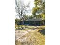 Quaint single-story home featuring a screened-in porch, a carport and a long driveway at 922 Se 13Th St, Ocala, FL 34471