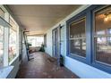 Inviting screened-in porch with blue trim, decorative tile, and a view of the surrounding neighborhood at 922 Se 13Th St, Ocala, FL 34471