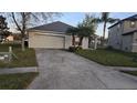Charming single-story home with attached two car garage and long driveway at 1907 Eliza Ann St, Kissimmee, FL 34758