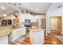 The well-lit kitchen features stainless steel appliances, stone countertops, and white cabinets at 6830 Krenson Oaks Cir, Lakeland, FL 33810