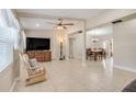 Spacious living room with tile floors, ceiling fan, and an open layout that leads to the dining area at 1220 George St, Winter Springs, FL 32708