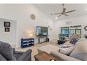 Bright living room featuring a ceiling fan, neutral paint, and a sliding door to the patio at 4101 Poinciana Dr, Indian Lake Estates, FL 33855