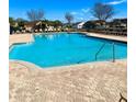 Beautiful community pool featuring a poolside clubhouse and ample seating at 3088 Pointe Place Ave, Kissimmee, FL 34758