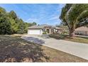 Beautiful one-story home featuring a spacious driveway and attractive landscaping at 562 Dowling Cir, Lady Lake, FL 32159