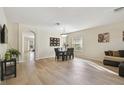 Bright and open living area featuring hardwood floors, a dining set, and contemporary decor at 1713 Altavista Cir, Lakeland, FL 33810