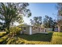 Expansive backyard with lush greenery and mature trees, offering a serene outdoor living space at 6317 Georgia Ave, Lakeland, FL 33813
