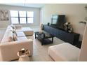 Stylish living room showcasing a large sectional sofa, sleek entertainment center, and a large window at 2206 Old Mining Rd, Lakeland, FL 33801