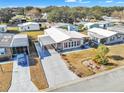 Bright, single-story home featuring a carport and beautiful landscaping at 1612 Cog Hill Dr, Lady Lake, FL 32159