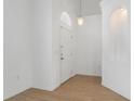 Bright foyer with tile flooring, a niche for decor, and a hanging pendant light fixture at 131 Vine Dr, Davenport, FL 33837