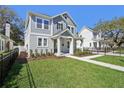 Charming two-story home with well-manicured lawn, covered porch, and craftsman style architecture at 2304 Depauw Ave, Orlando, FL 32804
