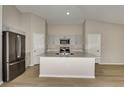 Bright kitchen with a large island, stainless steel appliances, and ample cabinet space at 1604 Ellesmere Ave, Haines City, FL 33844