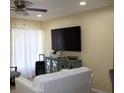 Bright living room featuring a ceiling fan, tile floors, and plenty of space for entertaining guests at 17 Trotters Cir, Kissimmee, FL 34743