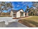 View of stucco home, showing garage and driveway at 7 Hill Prince Dr, Ocala, FL 34482