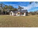Charming single-story home with a well-manicured lawn and stone accents at 7 Hill Prince Dr, Ocala, FL 34482