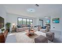 Bright living room with stylish furniture, plush rug, and tasteful decor at 2310 Laguna Dr, Indian Lake Estates, FL 33855