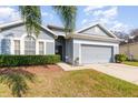 Charming single-story home with a manicured lawn, two-car garage, and freshly painted exterior at 339 Magical Way, Kissimmee, FL 34744