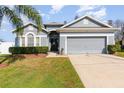 Charming single-story home with a manicured lawn, two-car garage, and freshly painted exterior at 339 Magical Way, Kissimmee, FL 34744