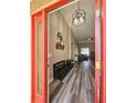 Welcoming foyer with wood-look flooring, modern lighting, and an open view into the living spaces at 5685 Lake Victoria Dr, Lakeland, FL 33813