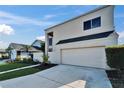 Modern exterior showcasing a two-car garage, contemporary design, and a well-kept lawn at 616 Peninsular Dr, Lakeland, FL 33813