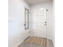 Bright entryway with white walls, vinyl floor and a mirror on the coat closet door at 456 Hilltop Dr, Lake Wales, FL 33853