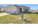 Well-maintained front yard featuring an agave plant centered in a circular stone bed at 456 Hilltop Dr, Lake Wales, FL 33853