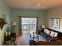 Cozy living room featuring a ceiling fan, comfortable seating, and sliding glass doors to the patio at 705 Gran Bahama Blvd # 705, Davenport, FL 33897