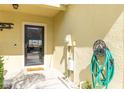 Front door entrance featuring a welcome mat and a mounted hose at 380 Arbor Lakes Dr, Davenport, FL 33896