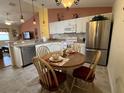 Kitchen area with stainless steel appliances, granite countertops, seating and dining area at 992 Davit Pl, The Villages, FL 32162