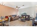 Spacious living room with tile floors, ceiling fan, and comfortable seating arrangement at 12313 Citruswood Dr, Orlando, FL 32832