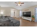 Spacious living room with wood flooring, a vaulted ceiling, a ceiling fan, and lots of natural light at 1426 Powhatan Ct, Lakeland, FL 33805