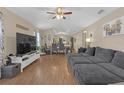 Open concept floor plan with living room flowing into the dining room and kitchen with gray furnishings at 1426 Powhatan Ct, Lakeland, FL 33805