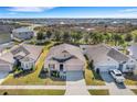 Expansive aerial view of a single-Gathering home in a residential area featuring a well-manicured lawn and mature landscaping at 3214 Bayou Bay Dr, Lakeland, FL 33811