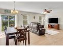 Open-concept living room and dining area, featuring modern flooring, natural light, and comfortable seating at 3214 Bayou Bay Dr, Lakeland, FL 33811