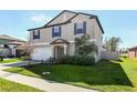 A charming two-story home with a well-manicured lawn, neat landscaping, and a two-car garage at 4323 Trotters Way, Lakeland, FL 33801
