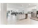 Bright, open-concept kitchen with granite countertops, stainless steel appliances, and a connected living area at 4323 Trotters Way, Lakeland, FL 33801