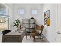 Serene home office featuring modern decor, ample natural light, and a comfortable work space at 8731 Sw 57Th Ln, Ocala, FL 34481