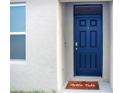 Inviting entryway with a stylish blue door and a 'Hello Fall' themed welcome mat at 469 Liu Ln, Deland, FL 32724