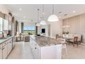 Bright, open kitchen featuring a large island, pendant lighting and stainless steel appliances at 5230 Sw 88Th Cir, Ocala, FL 34481