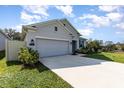 Single-story home showcasing the well-manicured lawn and front facade at 1006 Breggia Ct, Haines City, FL 33844