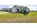 Well-manicured lawn leading to a gray single-Gathering home with attached garage at 1006 Breggia Ct, Haines City, FL 33844