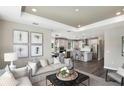 Open-concept living room showcasing an eat-in kitchen, island with seating, pendant lights and stainless steel appliances at 1671 Ruby Ln, Lake Alfred, FL 33850