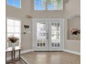 Bright foyer features double doors, high ceilings, and decorative accents, creating a welcoming entrance at 2410 Berkshire Ct, Kissimmee, FL 34746