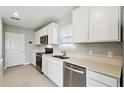 Bright kitchen with stainless steel appliances, white cabinets and stone countertops at 288 Woodsage Pl, Lake Alfred, FL 33850
