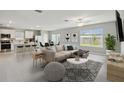 Bright open-concept living space features modern furnishings and tile flooring at 288 Woodsage Pl, Lake Alfred, FL 33850