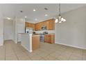 Light and bright kitchen with stainless steel appliances and tile flooring at 3890 Wood Thrush Dr, Kissimmee, FL 34744