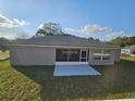 Backyard view of home, showcasing a screened-in porch and a spacious lawn at 1260 Buckeye Ne Rd, Winter Haven, FL 33881